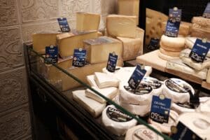 Assortment of cheeses displayed in a shop.
