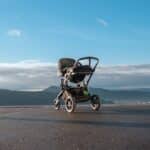 a stroller sitting on the side of a road