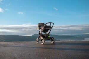 a stroller sitting on the side of a road