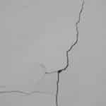 a crack in the side of a white wall