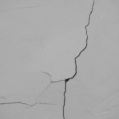 a crack in the side of a white wall