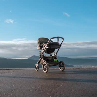 a stroller sitting on the side of a road