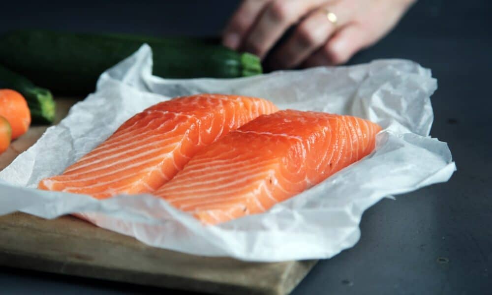 raw fish meat on brown chopping board