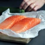 raw fish meat on brown chopping board