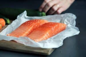 raw fish meat on brown chopping board