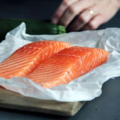raw fish meat on brown chopping board