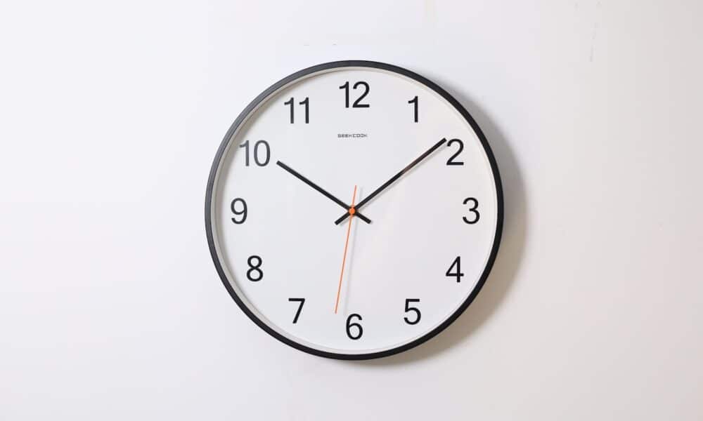 round analog wall clock pointing at 10:09